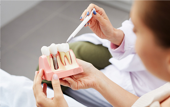 Over-the-shoulder view of dental brushing demonstration.